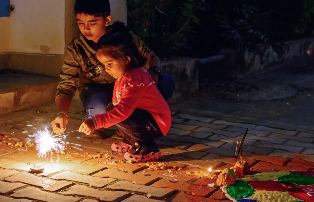 Children playing with lights and fireworks during the Tihar Festival in Nepal