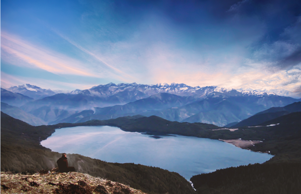 Crystal-clear blue Rara Lake surrounded by pine forests and snow-capped mountains in western Nepal