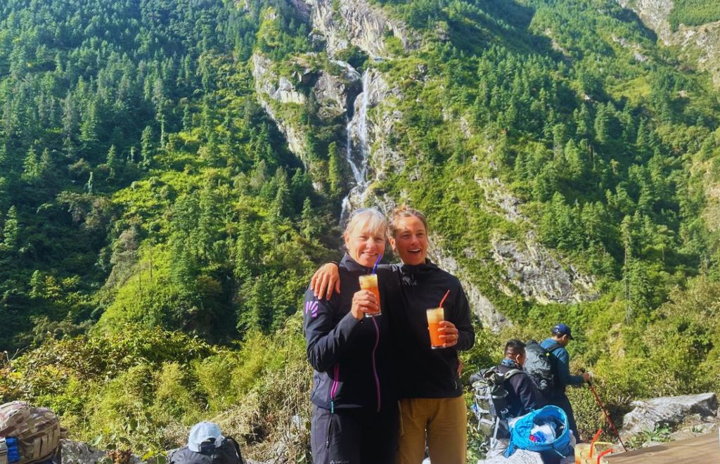 Trekkers enjoying fresh apple juice at Manaslu Circuit Trek